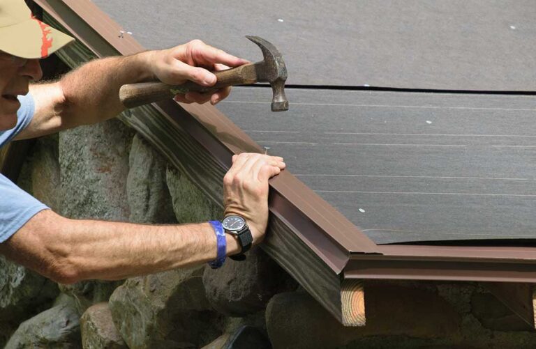 Homeowner checks roof shingles and gutters from the ground before a severe rainstorm.